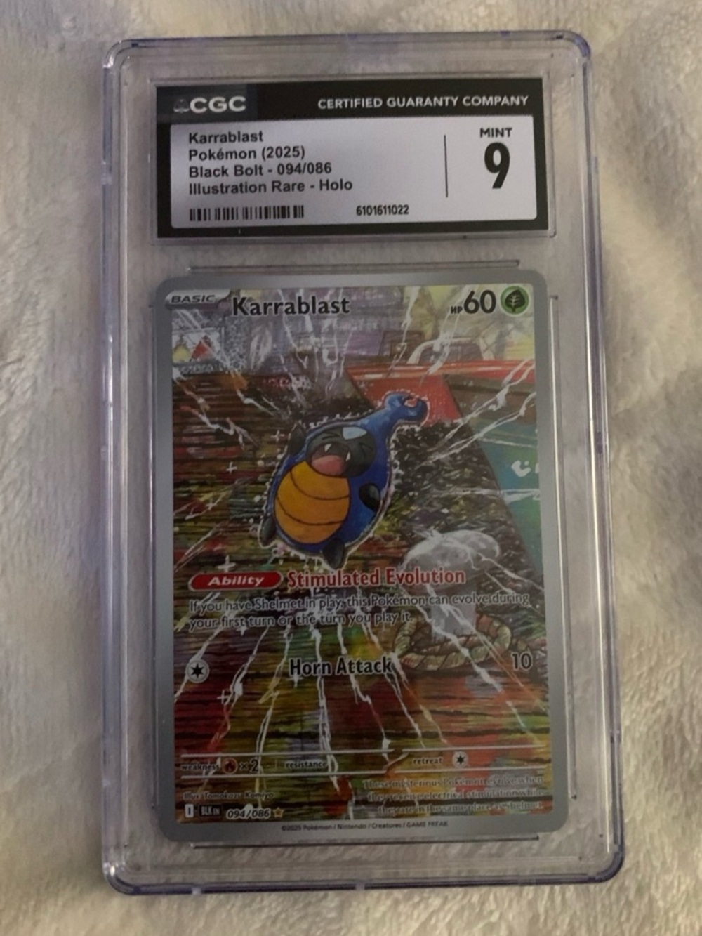 Graded Karrablast Pokémon Card (Blue/Yellow) - Mint 9